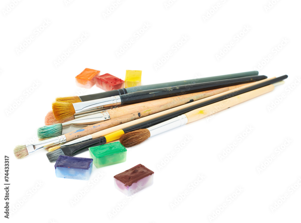 Multiple brushes next to a paint cases Multiple brushes next to a paint cases