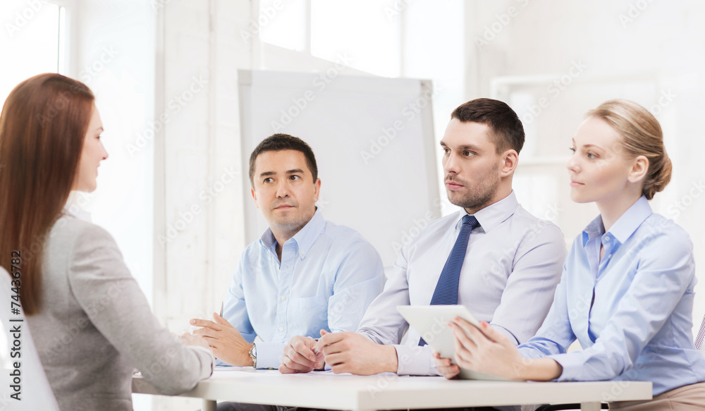 business team interviewing applicant in office business team interviewing applicant in office