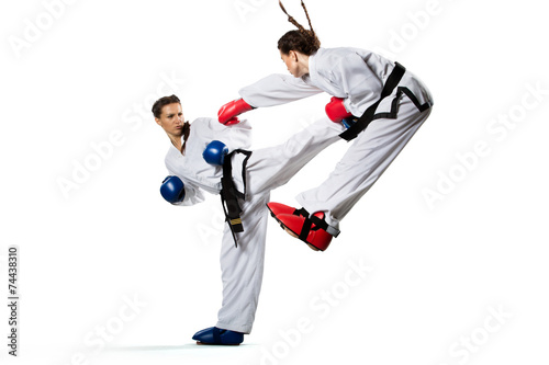 Two isolated professional female karate fighters are fighting