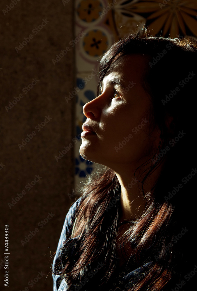 Fototapeta premium Backlight profile of a young beautiful woman