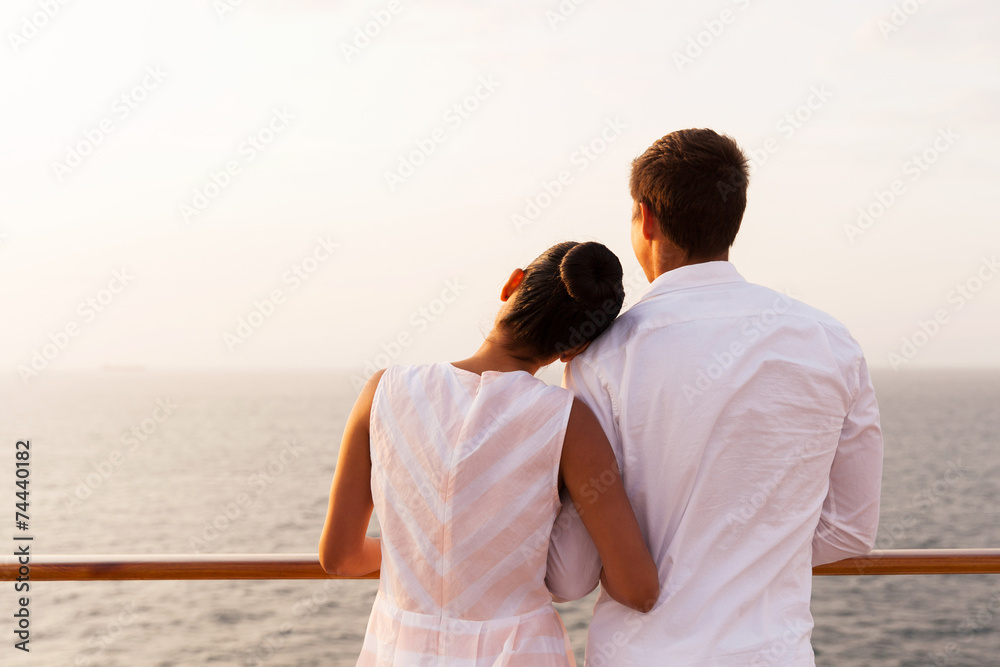 young couple enjoying sunset on cruise young couple enjoying sunset on cruise