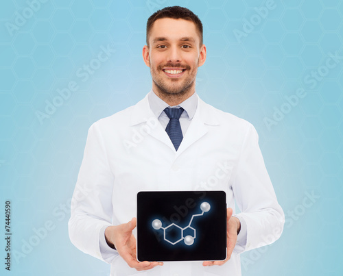 smiling male doctor showing tablet pc screen photo