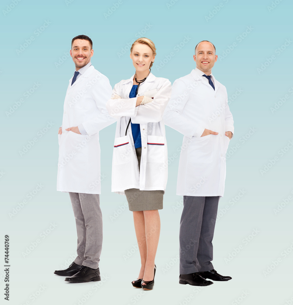 group of smiling doctors in white coats group of smiling doctors in white coats