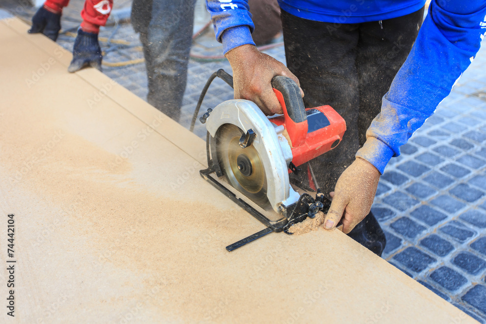 A carpenter works on woodworking the machine tool. A carpenter works on woodworking the machine tool.