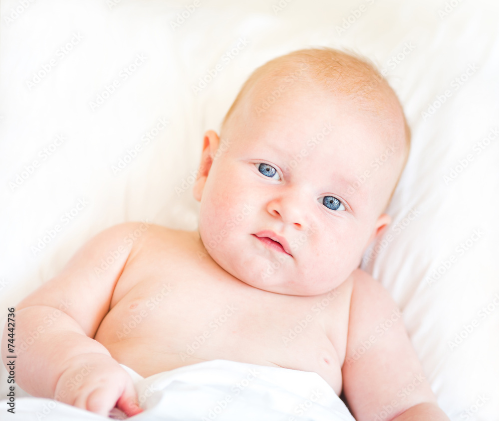 Peaceful newborn baby lying on a bed Peaceful newborn baby lying on a bed
