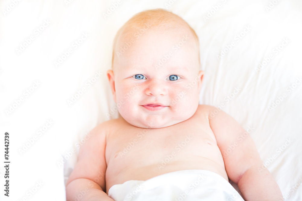 Peaceful newborn baby lying on a bed Peaceful newborn baby lying on a bed