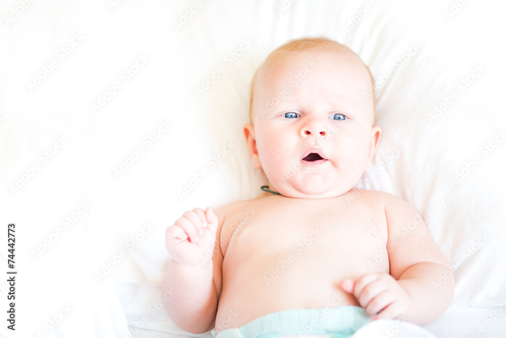 Peaceful newborn baby lying on a bed Peaceful newborn baby lying on a bed