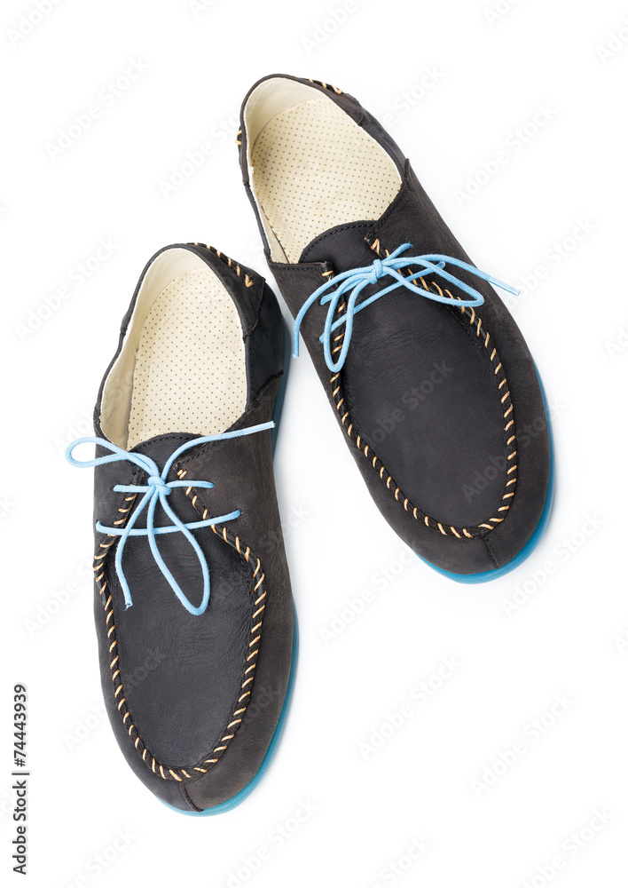 Fototapeta premium Black men's leather loafers with blue soles and laces on a white