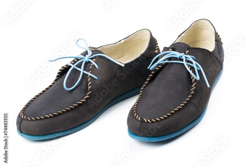 Black men's leather loafers with blue soles and laces on a white