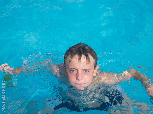 9 year old boy having fun in swimming pool