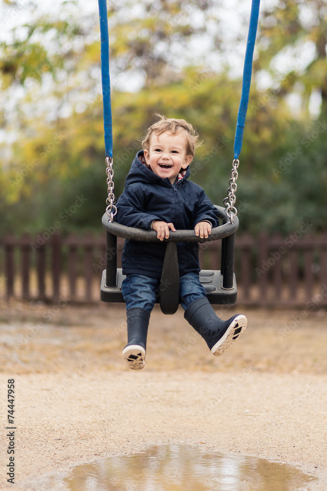 happy little boy on a swing