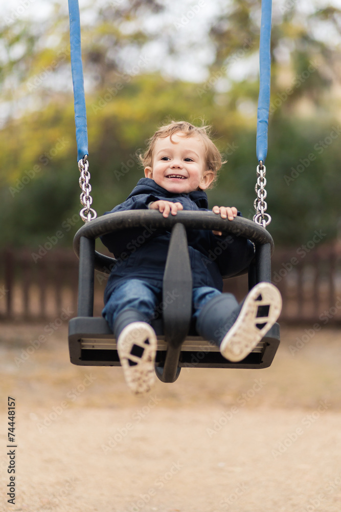 happy little boy on a swing