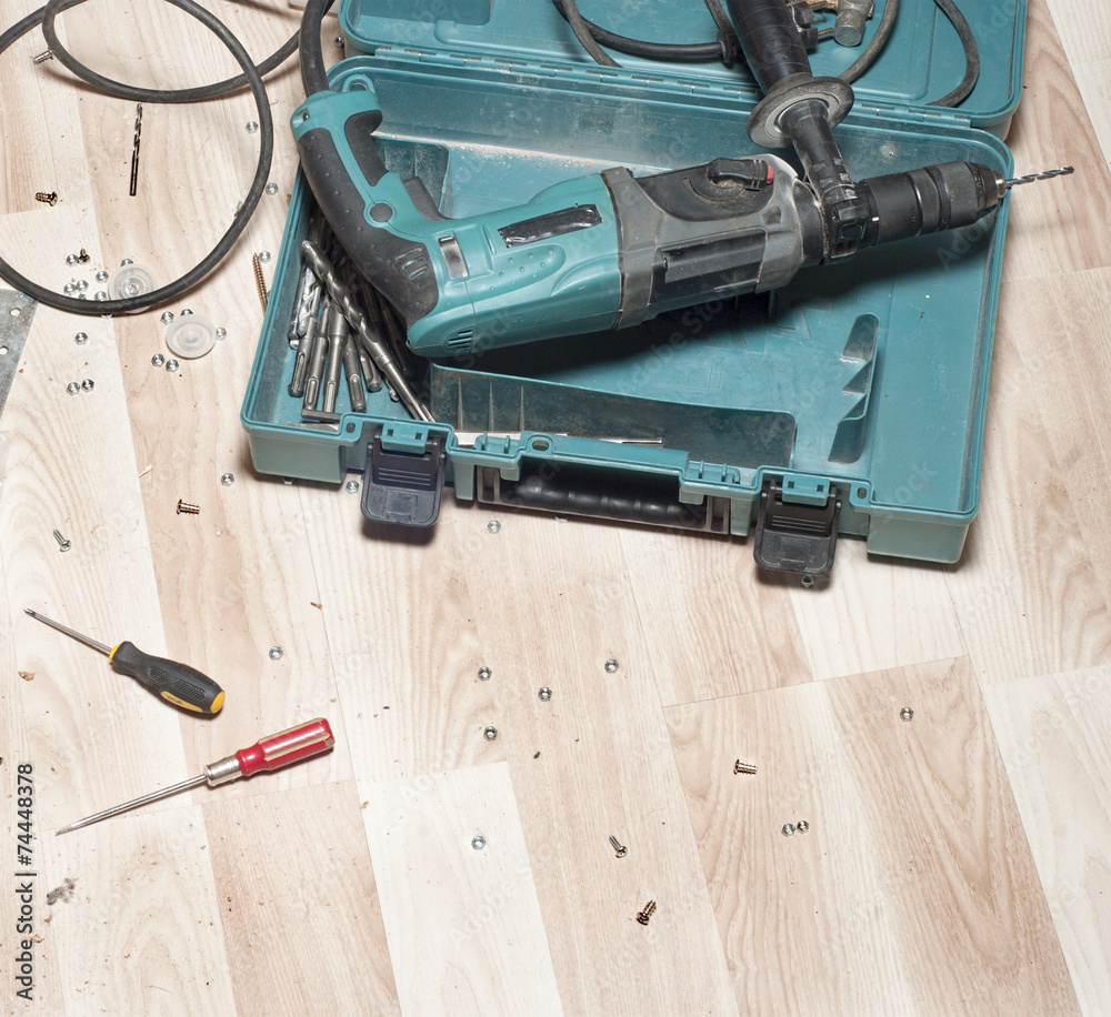 Electric drill on wooden floor