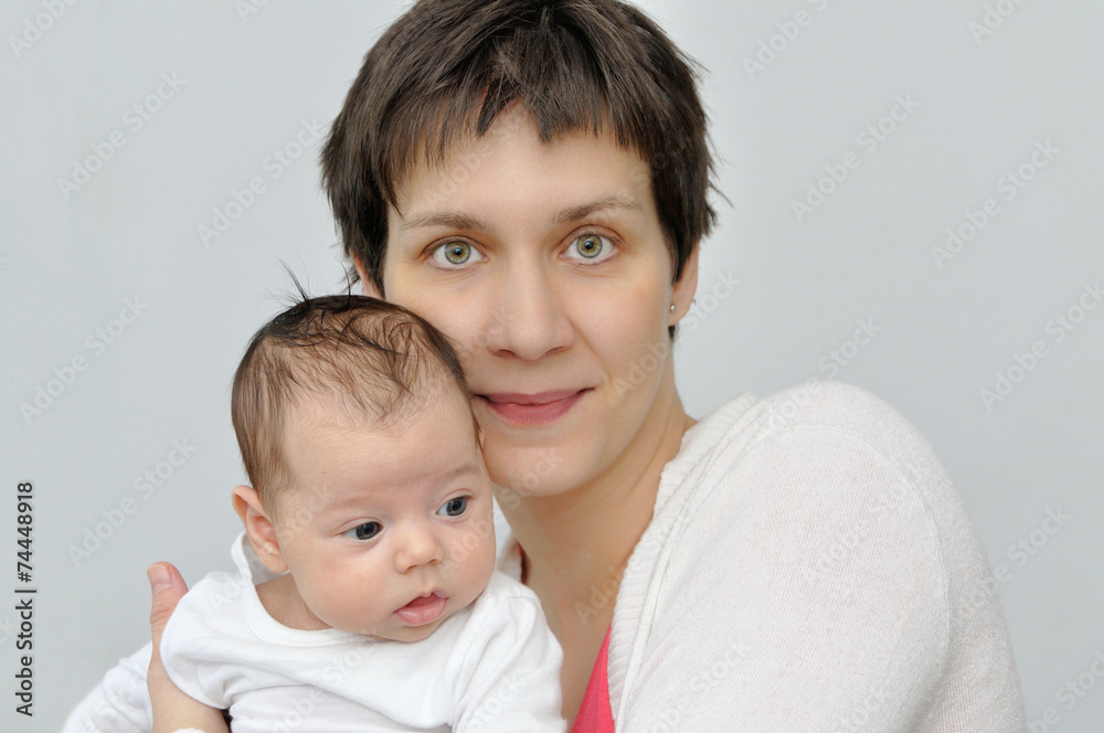 Happy mother holding her lovely newborn baby girl Happy mother holding her lovely newborn baby girl