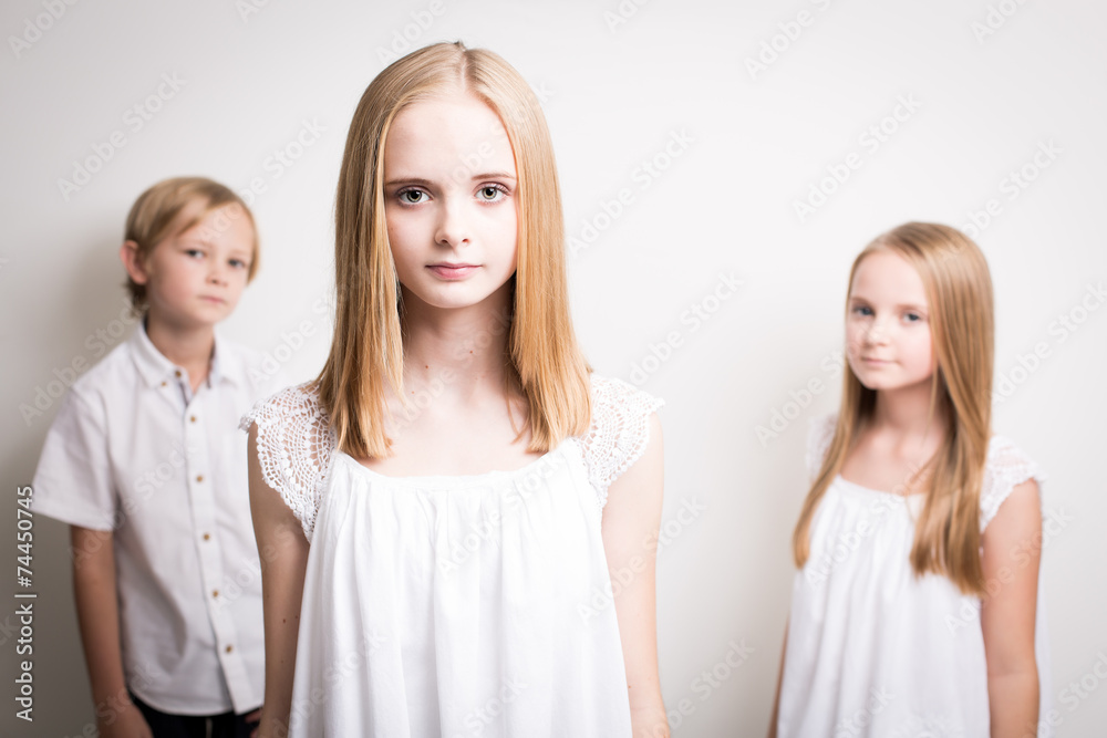 Two Sisters And Their Brother Dressed in White in the Studio Two Sisters And Their Brother Dressed in White in the Studio