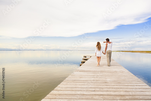 Couple walking and pointing to the horizon