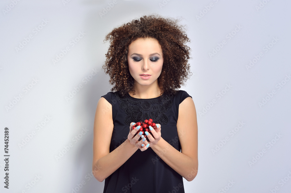 Beautiful woman holding cherry