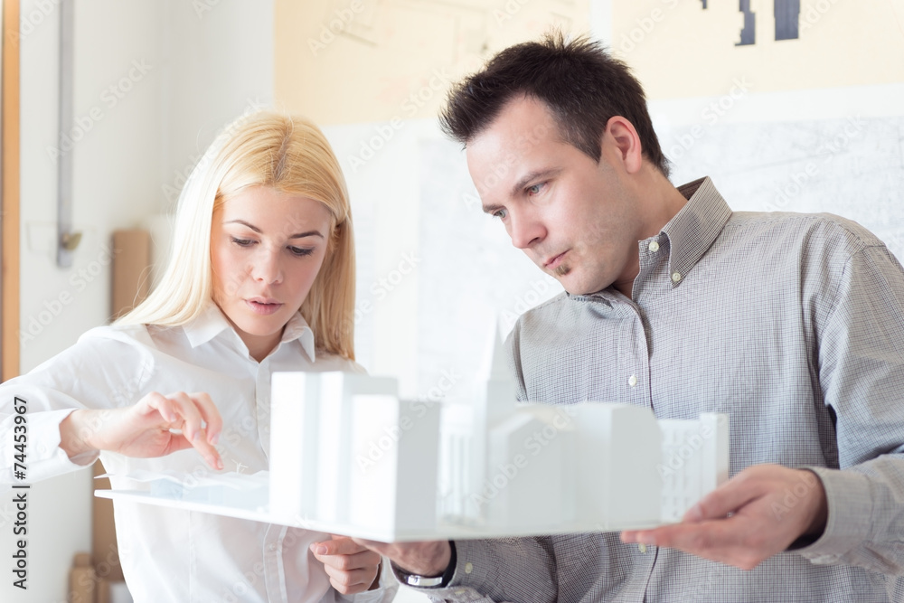 Architect Working on a model building Architect Working on a model building