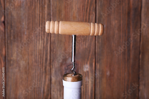 Bottle opener close-up, on wooden background