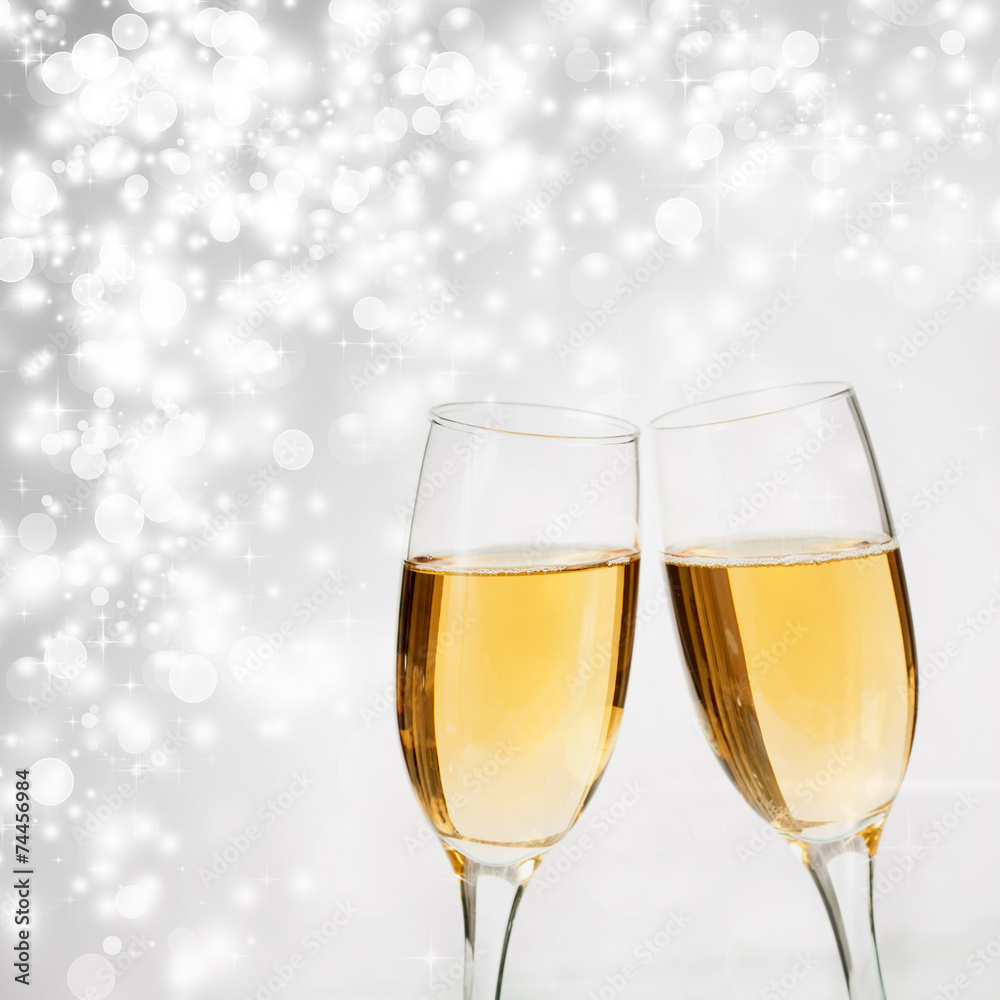 Champagne glasses against holiday lights Champagne glasses against holiday lights