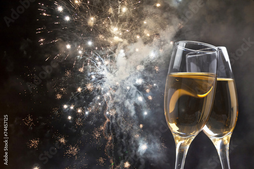 Glasses with champagne against fireworks
