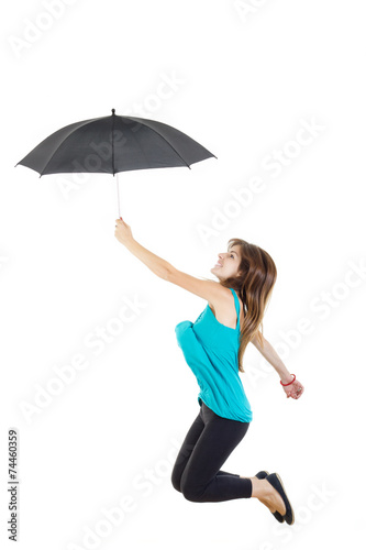  girl in blue t-shirt and black tights with umbrella jumping