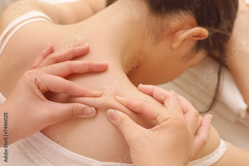 closeup asian woman having deep massage on her back in spa