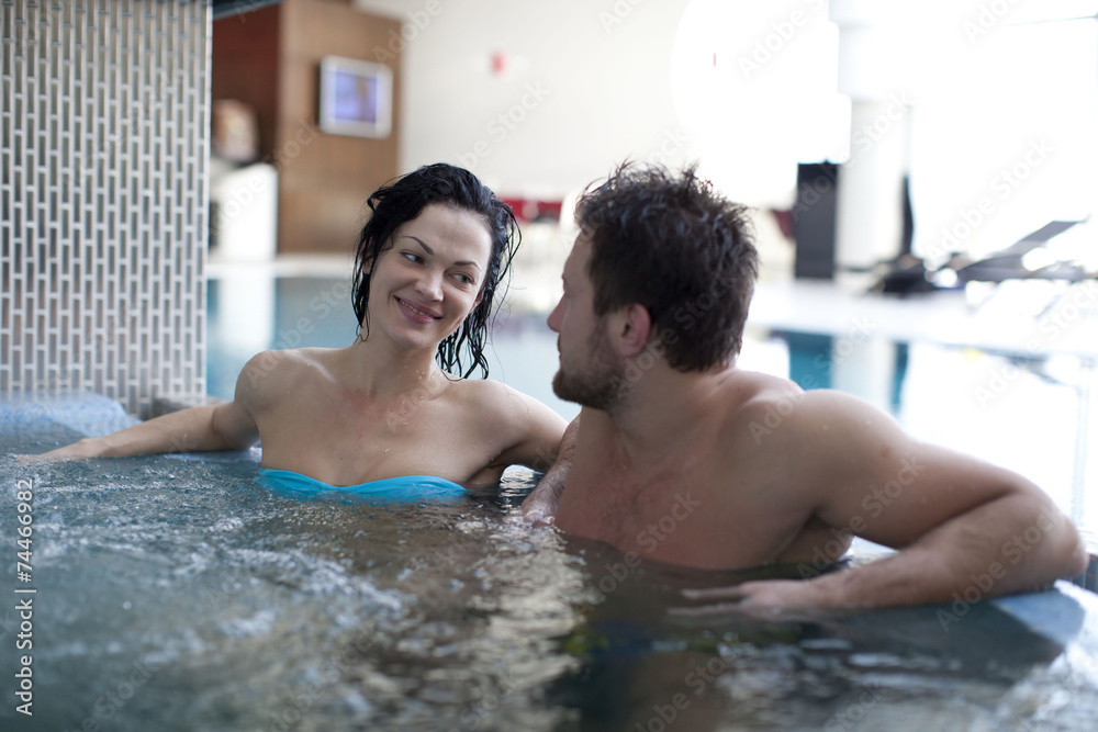 Couple relaxing in jacuzzi of spa center 