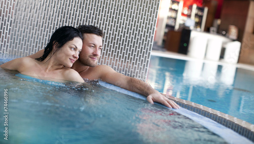 Couple relaxing in jacuzzi of spa center 