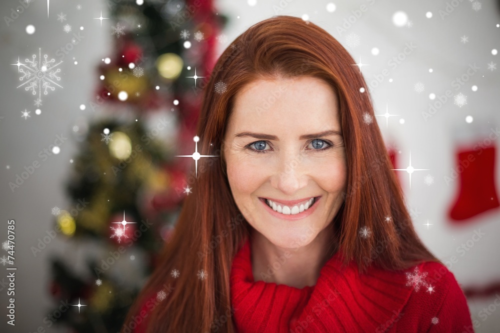 Composite image of festive redhead smiling at camera Composite image of festive redhead smiling at camera