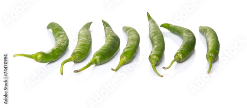 Green chili peppers over white background