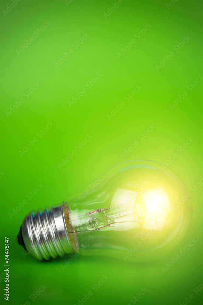 glowing light bulb over green background glowing light bulb over green background