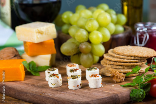 White cheese with herbs snacks with grapes and wine