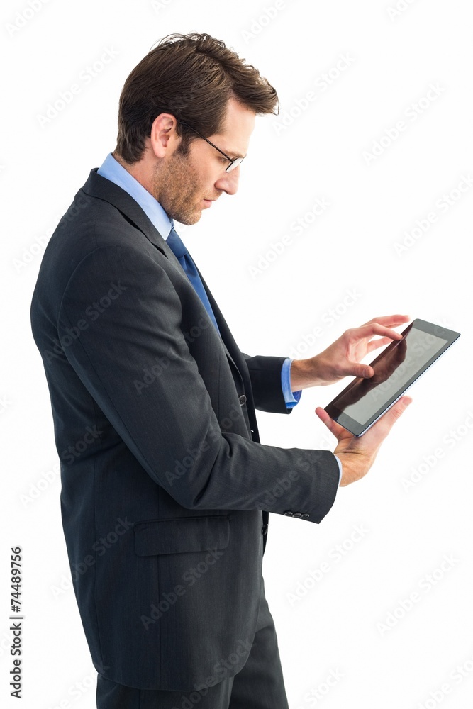 Businessman standing while using a tablet pc Businessman standing while using a tablet pc