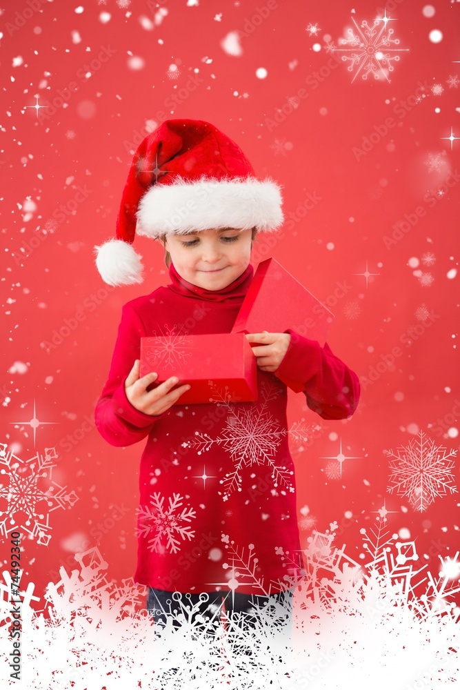 Composite image of festive little boy opening a gift Composite image of festive little boy opening a gift