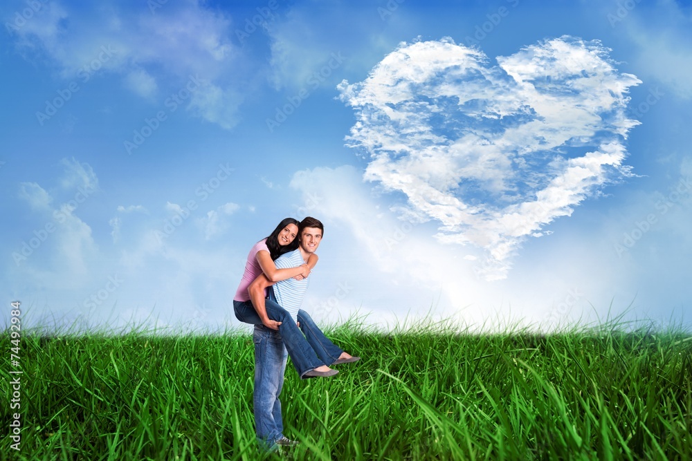 Composite image of young man giving girlfriend a piggyback ride Composite image of young man giving girlfriend a piggyback ride