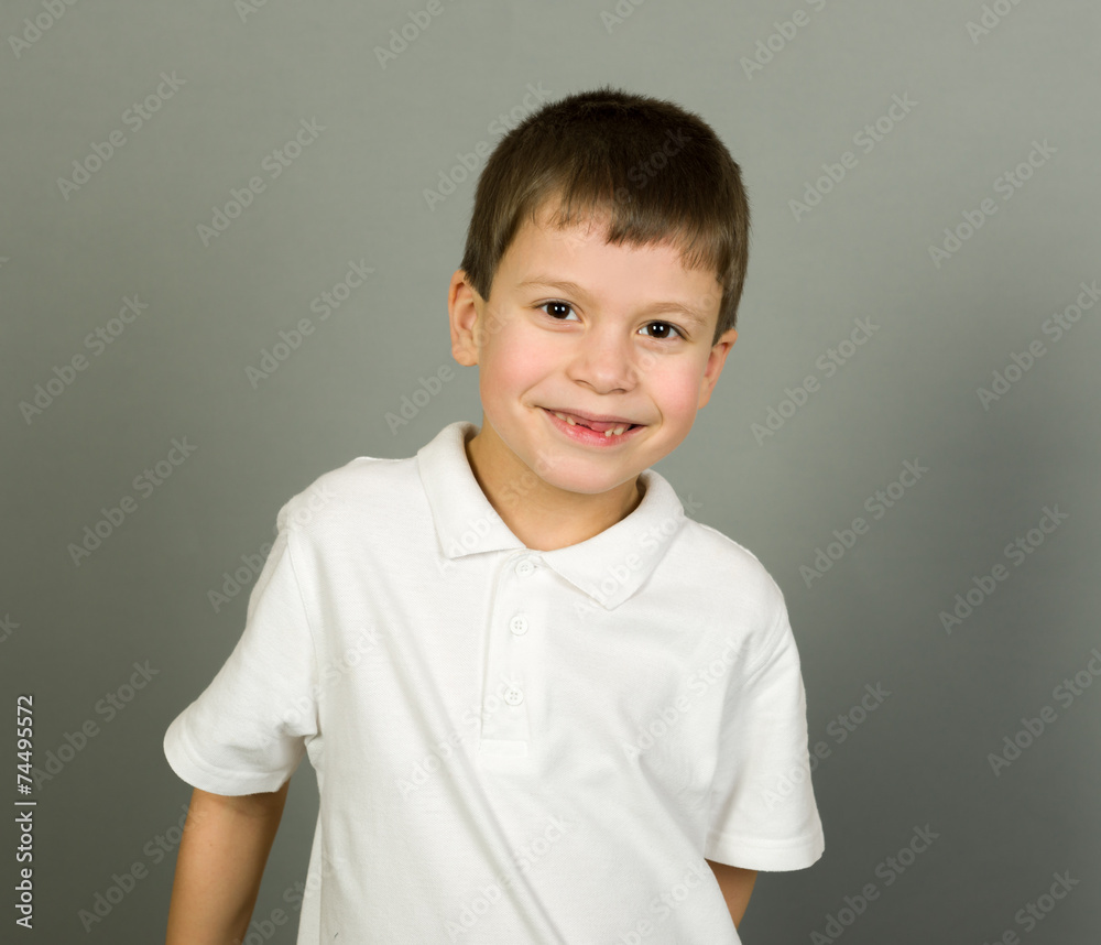 grimacing boy portrait on grey grimacing boy portrait on grey