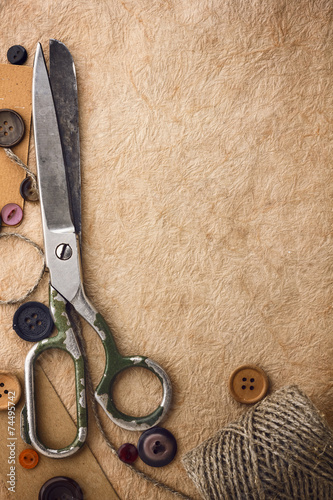 Old scissors and buttons on the paper