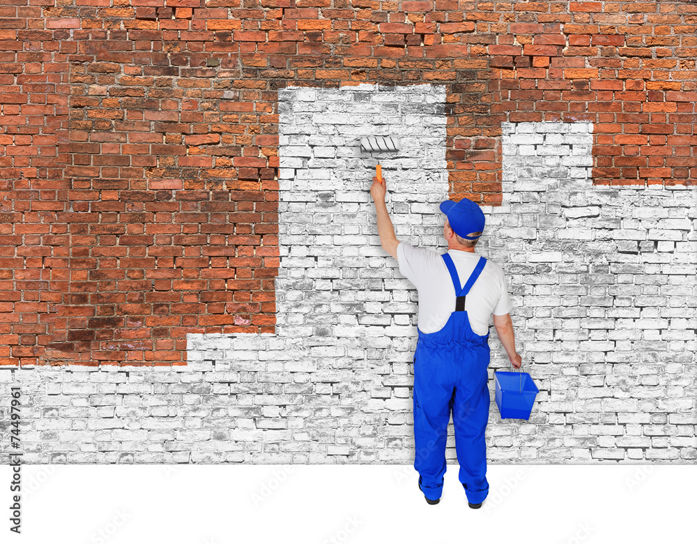 House painter covers brick wall with white paint House painter covers brick wall with white paint