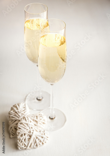 Two glasses of champagne with hearts photo