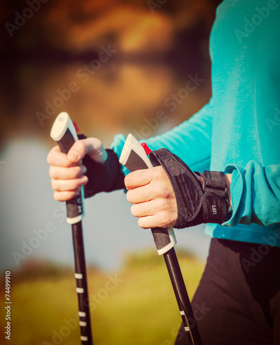 Woman's hand holding nordic walking poles
