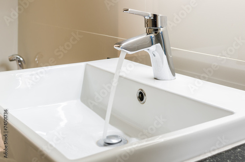 washbasin and faucet with water drop photo