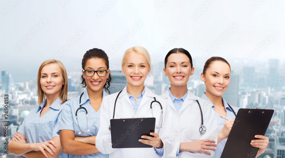 smiling female doctors and nurses with stethoscope smiling female doctors and nurses with stethoscope