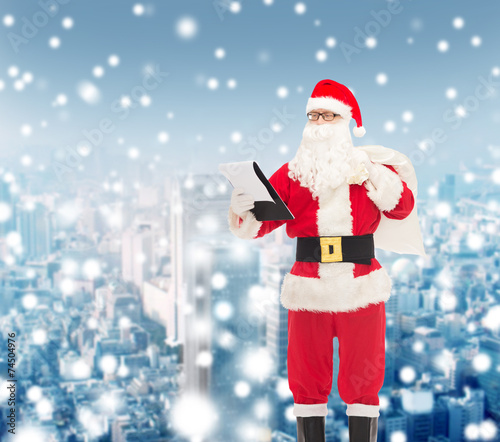 man in costume of santa claus with notepad and bag © Syda Productions