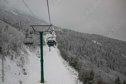 Skiers and snowboarders on a ski lift