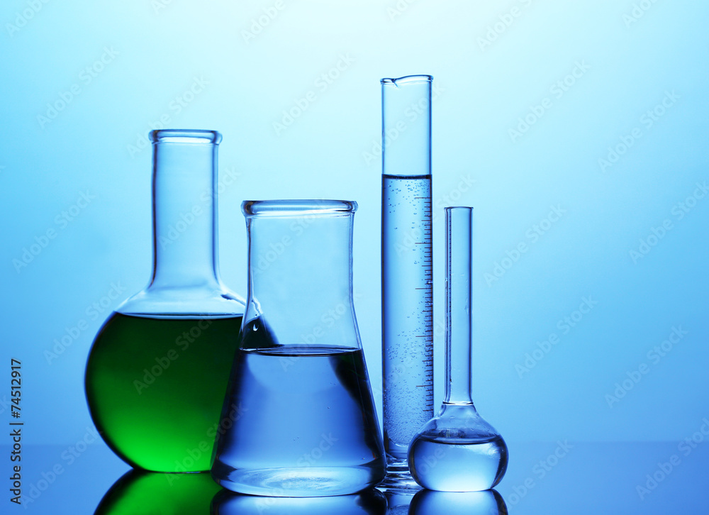 Test tubes with liquid on bright blue background Test tubes with liquid on bright blue background