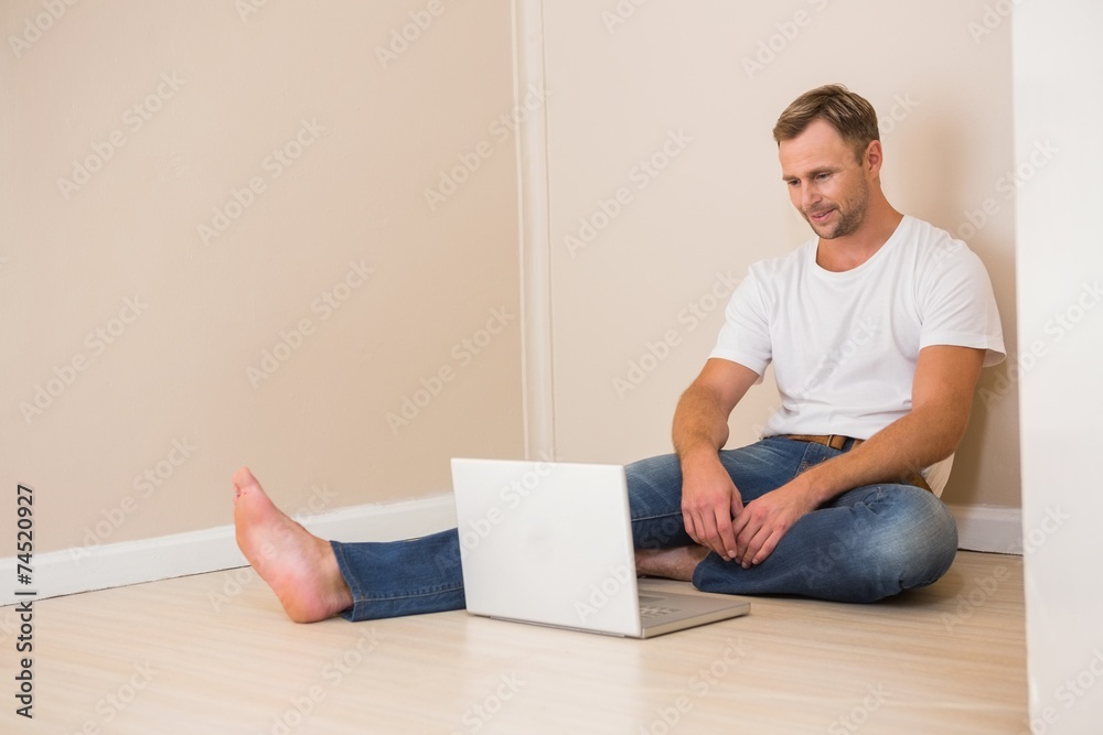 Happy man using laptop after moving in Happy man using laptop after moving in