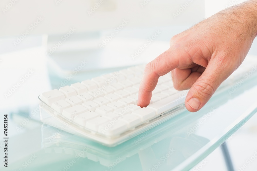 Businessman pushing key on keyboard Businessman pushing key on keyboard