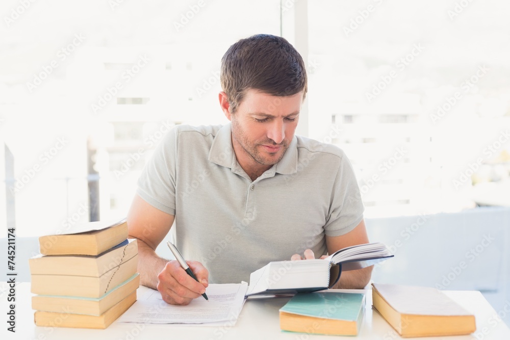 Casual businessman studying at his desk