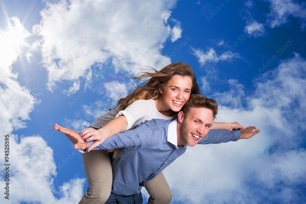 Composite image of smiling young man carrying woman Composite image of smiling young man carrying woman